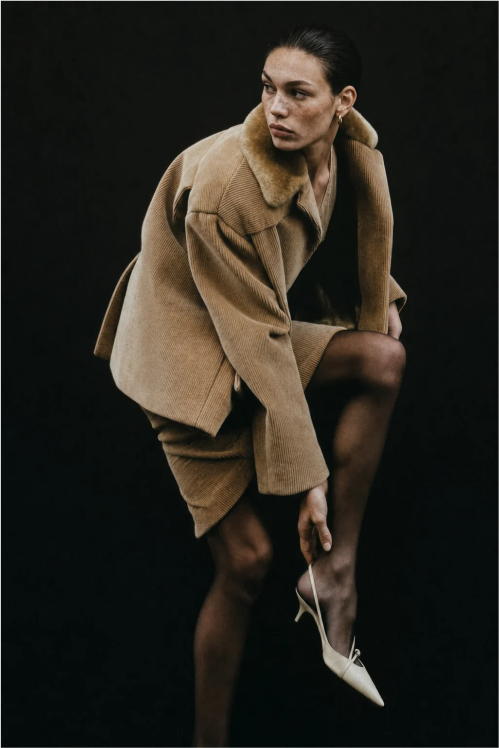Editorial concept showing the model in an oversized tan coat