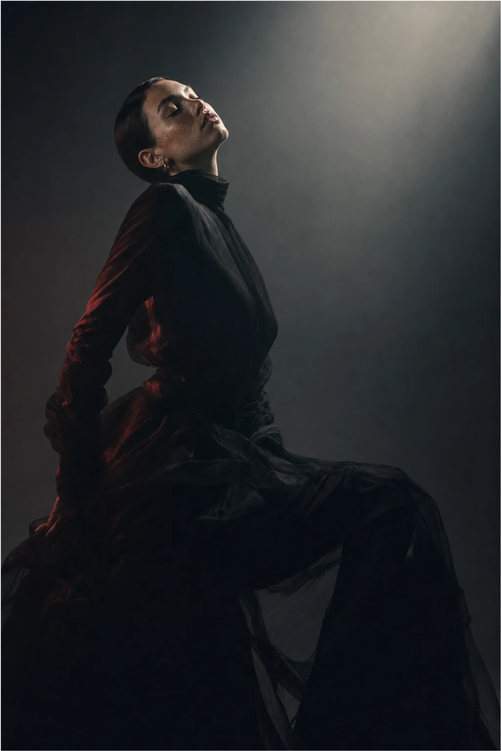 Moody portrait in a black dress with cool directional light